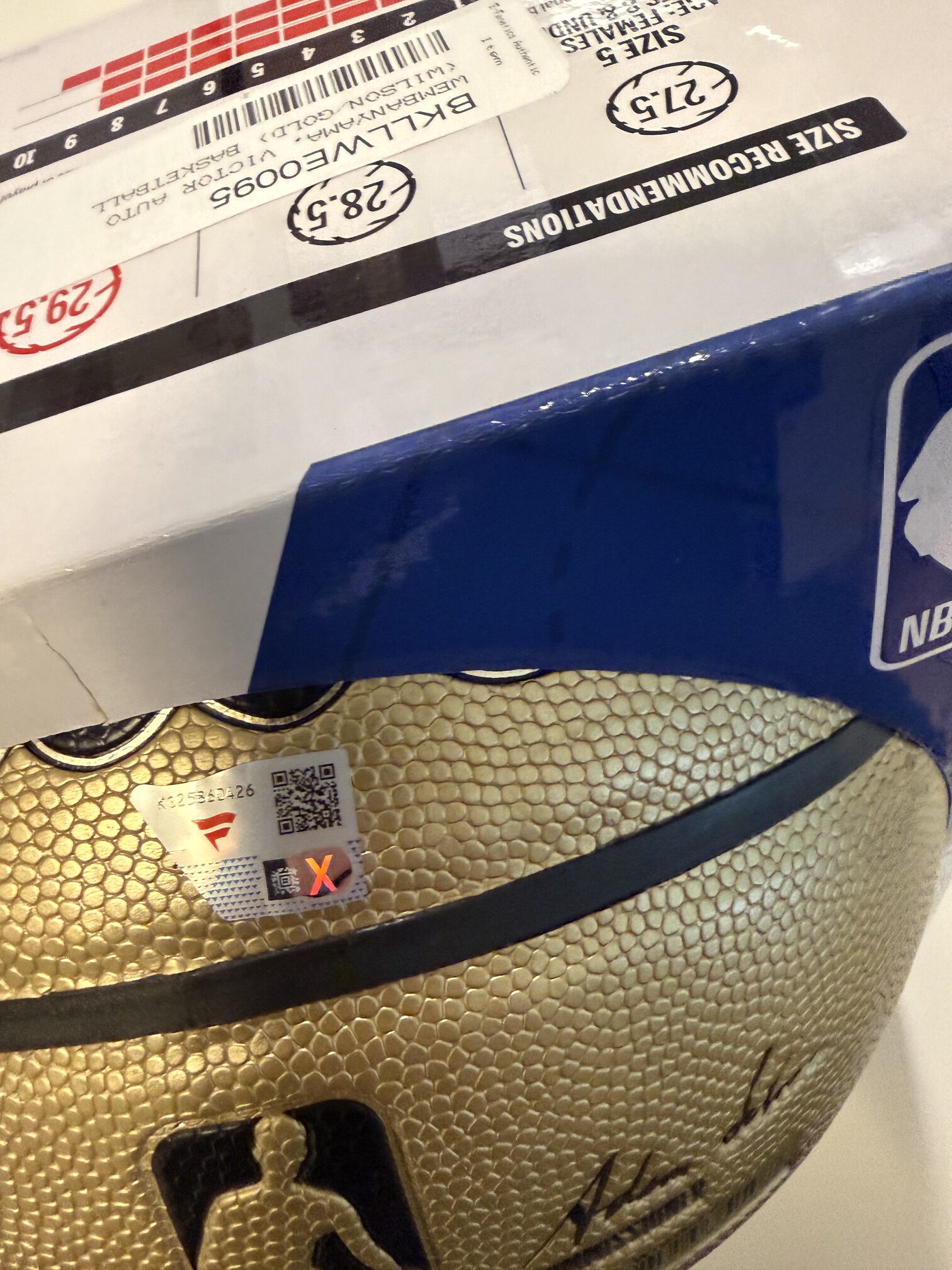 Signed Victor Wembanyama gold NBA basketball from Fanatics Authentic showing the signature.